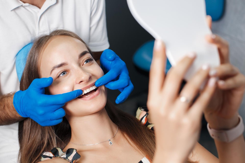 Patient viewing her smile during a cosmetic dental consultation