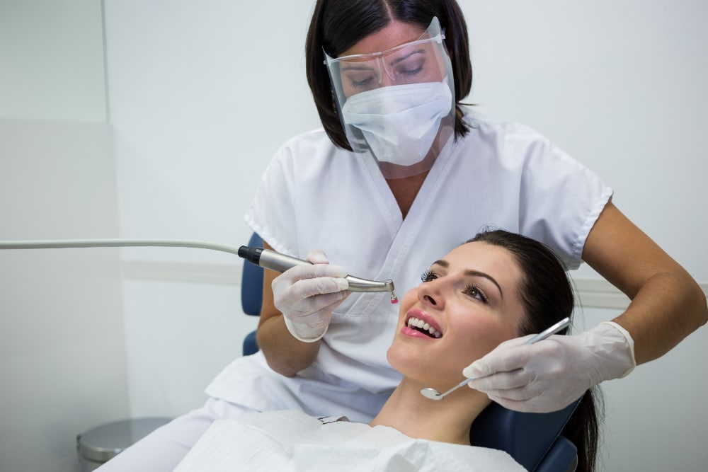Dentist examining a patient during a routine dental checkup and oral exam