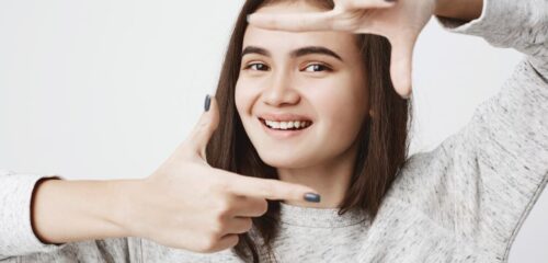 Smiling woman framing her teeth to highlight her smile